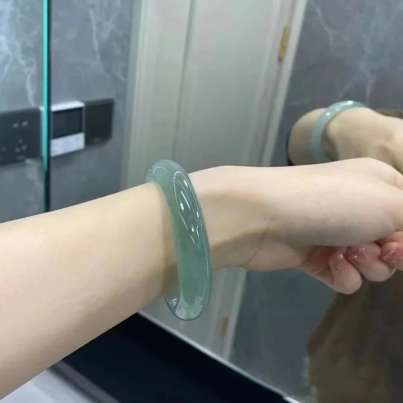 Natural Burmese old mine ice-type jade bracelet with floating blue patterns, clear water, and a fresh, vibrant green color, rese