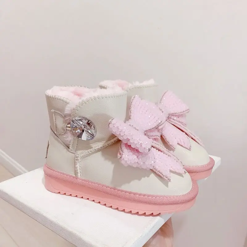 أحذية الثلوج الحرارية للفتيات لشتاء 2026 بفيونكة وردية كريستالية للكاحل غير قابلة للانزلاق من القطن الدافئ ​   الأحذية