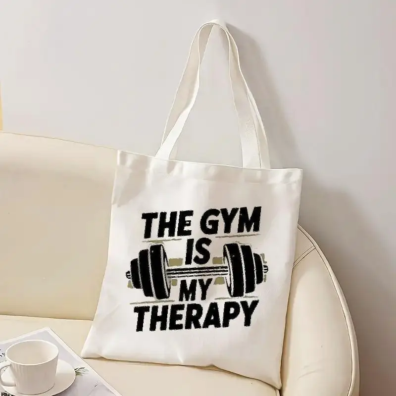 

The Gym Is My Therapy" Canvas Tote Bag - Sturdy Reusable Shoulder Bag Featuring A Weightlifting Design Great for Travel Shopping