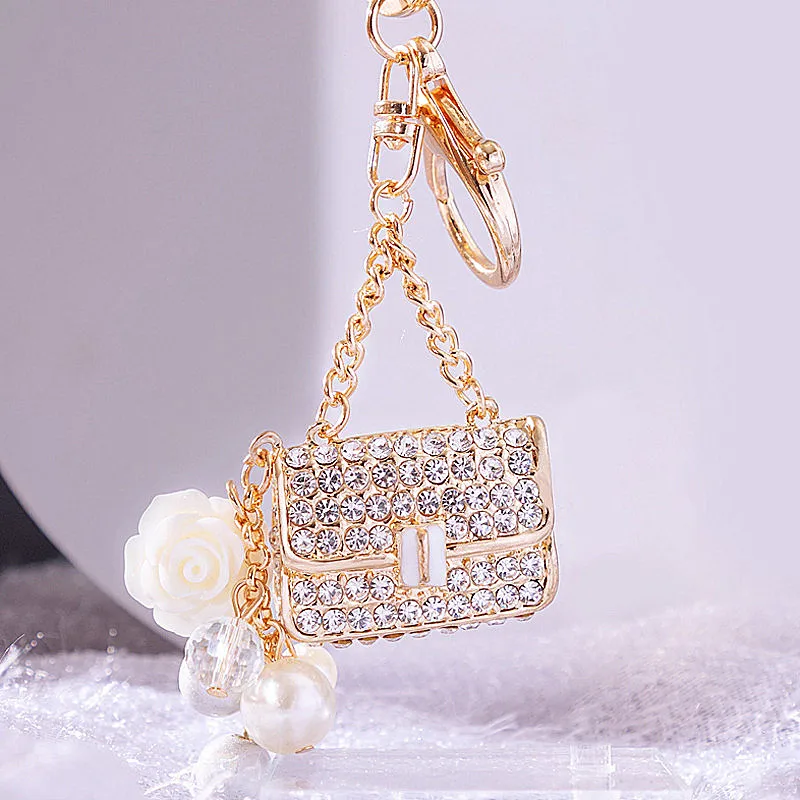 Pearl small fragrance small satchel keychain Women's bag pendant metal keychain ring diamond keychain.