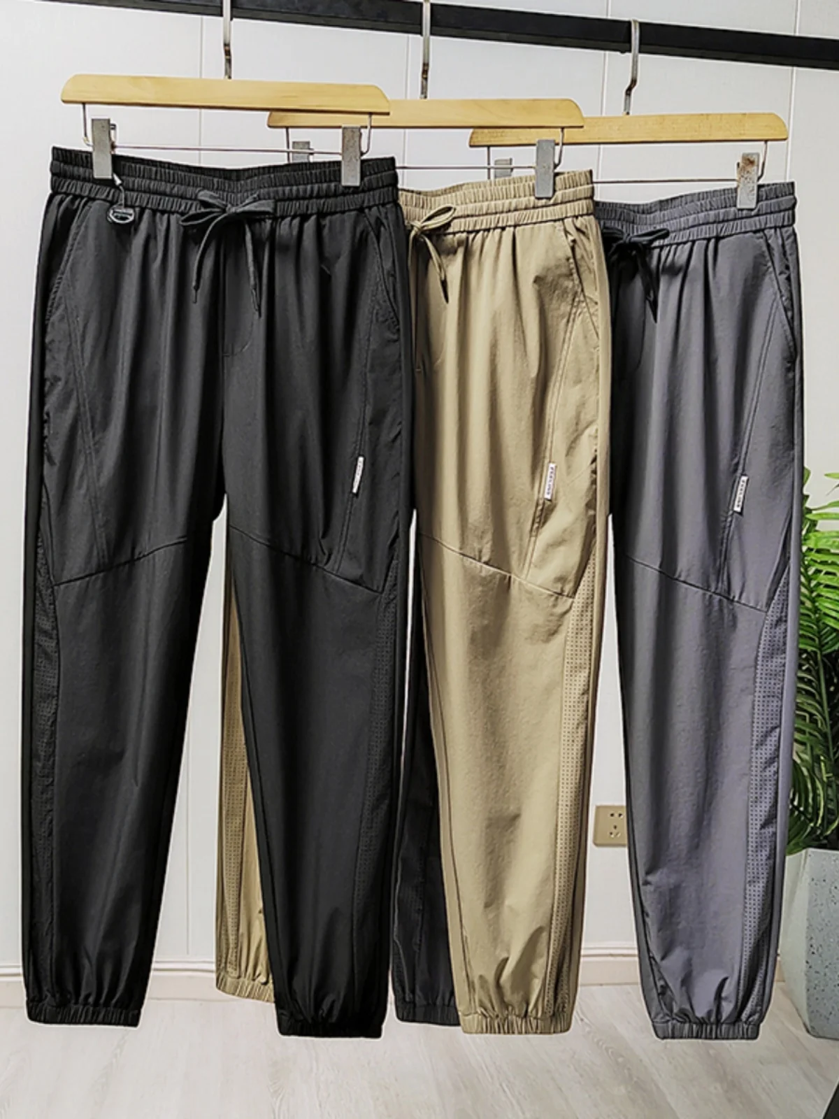 

New Ice Silk Waterproof Qui Dry Elastic Laser Perforated Breathable Thin Sports Casual Pants Men Summer Loose Fit Faion U...