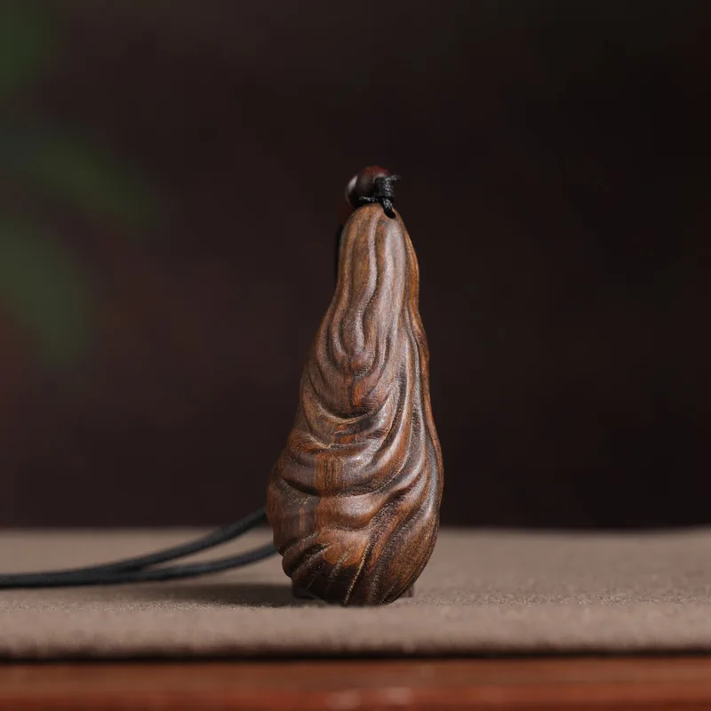 Wooden artifact: naturally shaped agarwood pendant with insect carvings, unique antique-style cultural ornament, suitab