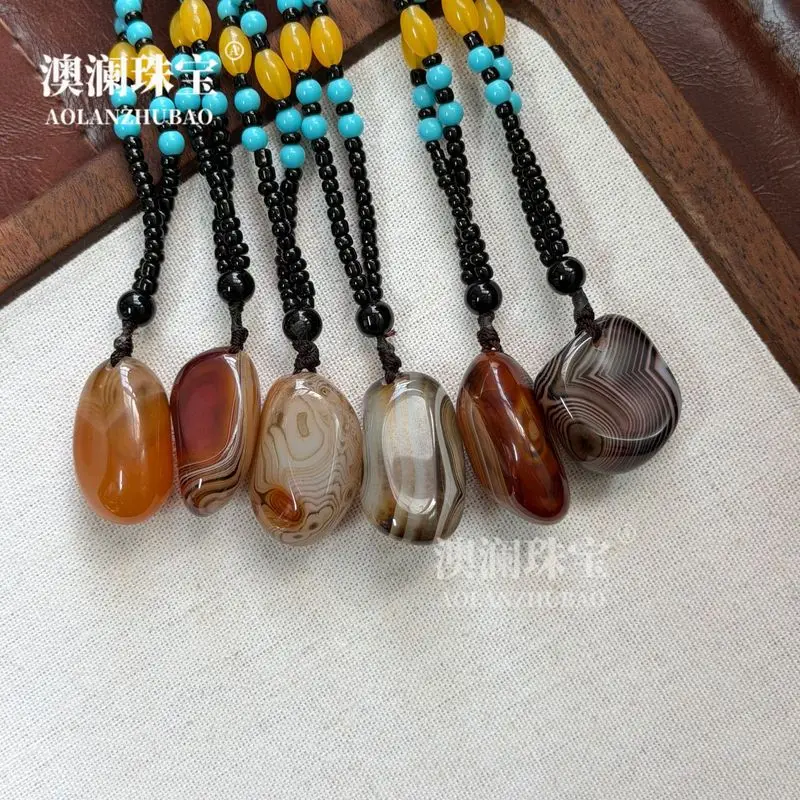 Natural silk-wrapped agate striped pendant pebble-shaped rain flower stone hand-held ornament raw stone polished with silk ag