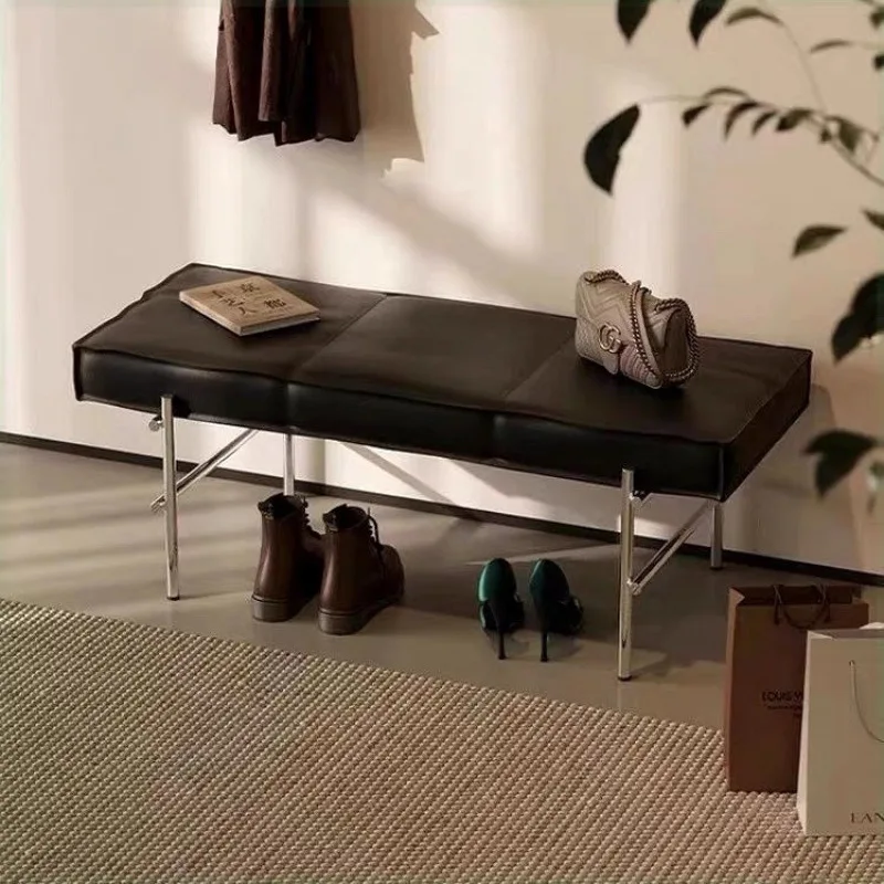 At door, household enters house, changes shoes, wears shoes, and enters  door with a stool.