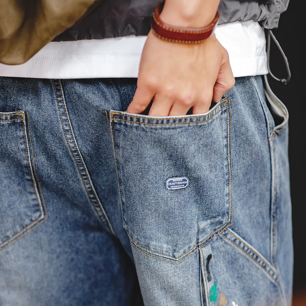 Maden Jeans Graffiti azzurri con inchiostro Splash per uomo Pantaloni da registrazione a gamba dritta lavati con texture fiammato da 9,2 OZ Jeans streetwear autunnali