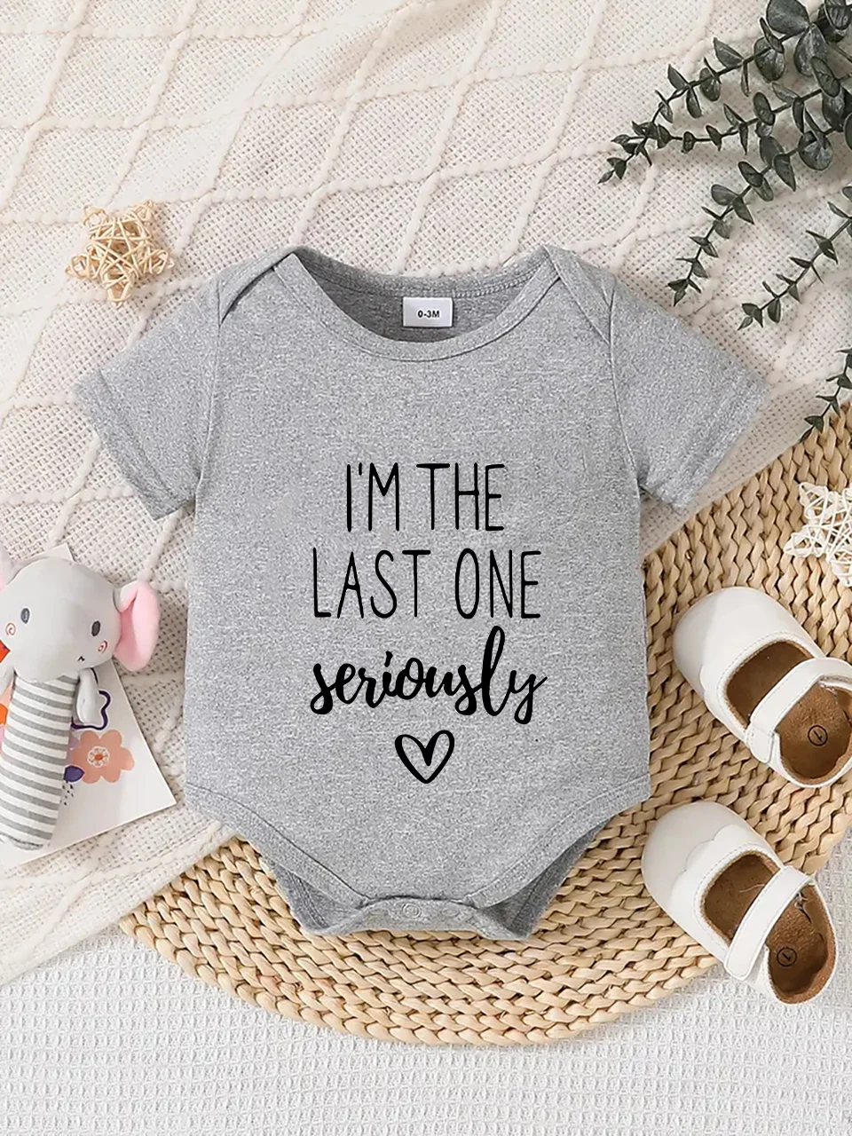 Playful letter-printed baby short-sleeve triangle bodysuit. Button closure for easy dressing