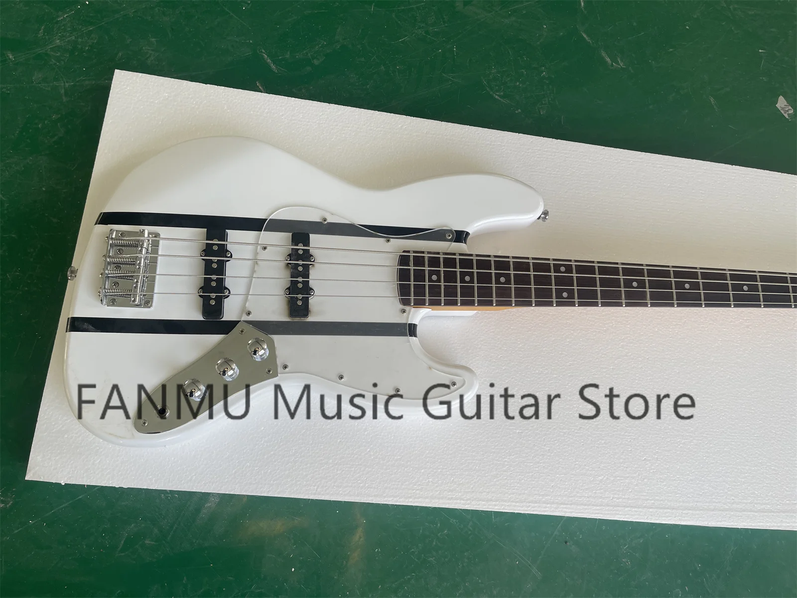 4 string bass, white body, black stripes, yellow maple neck, maple fingerboard, acrylic pickup board