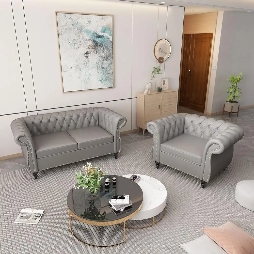 

Комплект из серого кожаного дивана и кресла с декоративными подлокотниками для гостиной