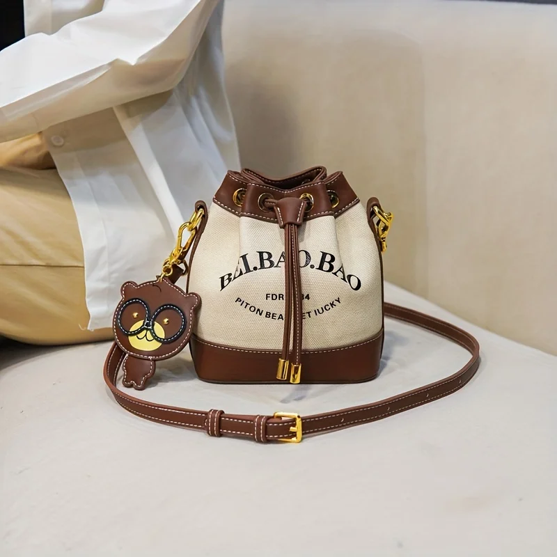 Chic Canvas Bucket Bag with Letter Design - Crossbody & Shoulder Style with Pendant, Drawstring Closure for Everyday Use