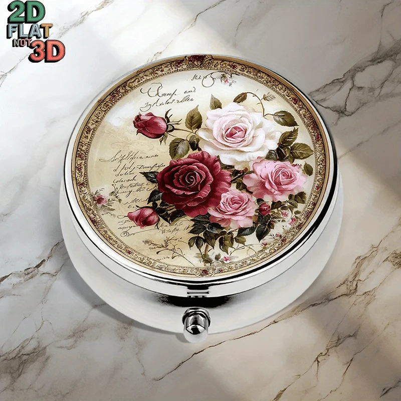 A flat, portable, round metal pill box, decorated with vintage rose and French love letter-style lettering, in pink, red, white, and cream tones, used for stylishly storing medication, vitamins, and other small items. Very suitable for travel and sports, it can be used as a small accessory for multifunctional storage and coin storage, and is also a thoughtful gift for relatives, friends, and elders. Beautifully designed containers keep your essential items organized and within reach, flat design