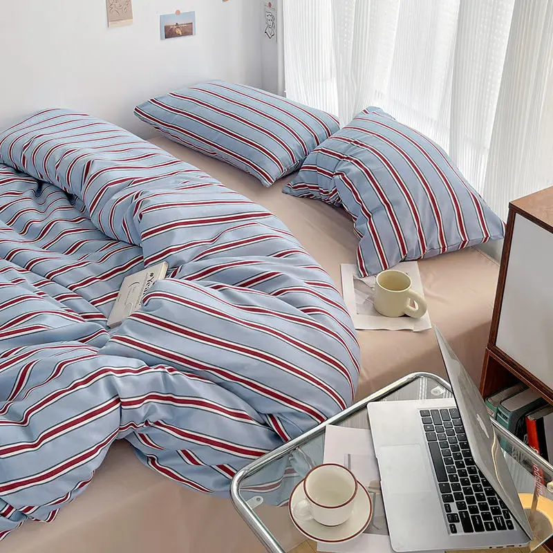 

Simple Red and Blue Striped Duvet Cover and Four Piece Bed Sheet Set with Washed Cotton Bedding on the Bed