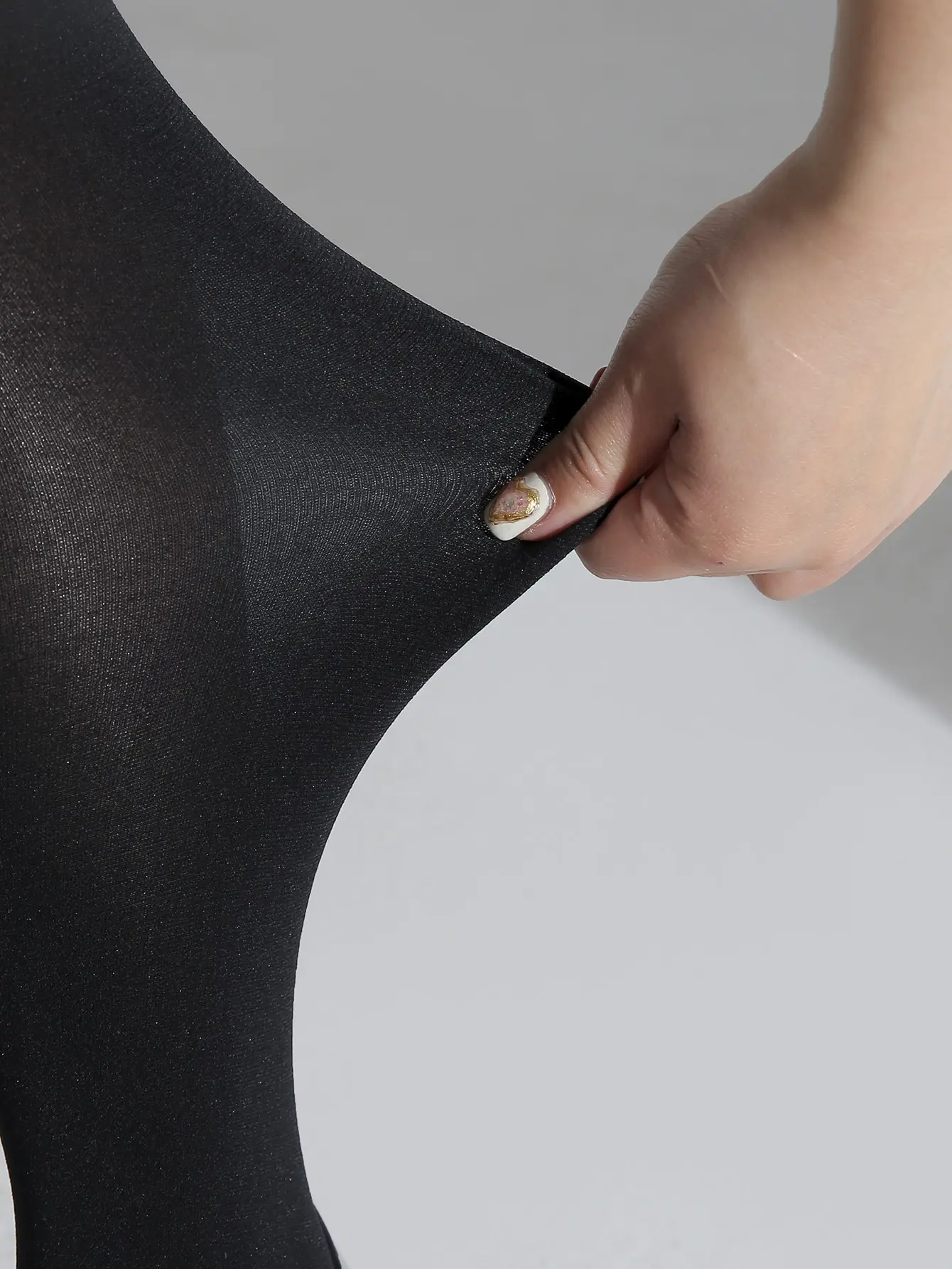 A fashionable women\'s solid black oversized pantyhose