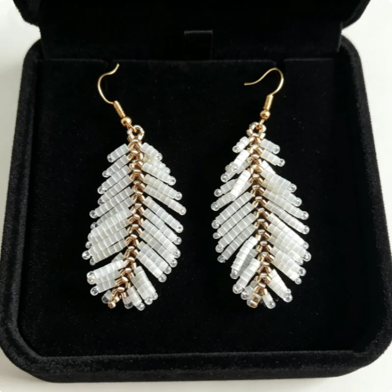 Two-Tone Feather-Shaped Earrings, with Crystals Arranged in a Methodical Way and Woven into a Tail-Feather Shape