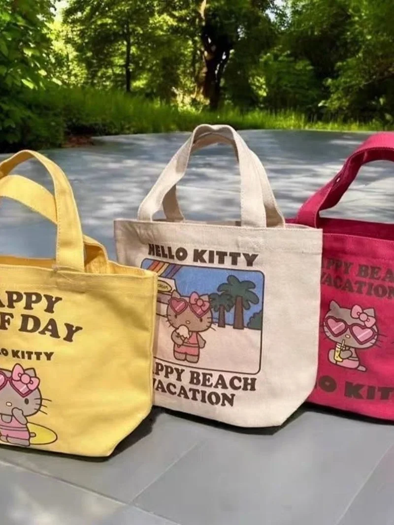 

New Cute Japanese Hawaiian Black Leather Hello Kitty Cartoon Canvas Handbag Bento Bag Dopamine Handheld Storage Bag