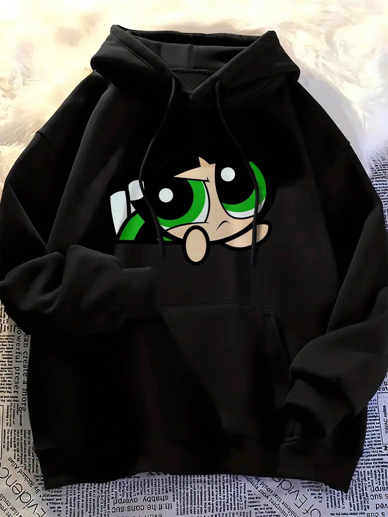 Black Hoodie with Cartoon Character Design - Front Featuring Big Green Eyes and Ponytail, Stylish and Unique Pullover for Casual Wear, Perfect for Fans of Fun and Whimsical Fashion