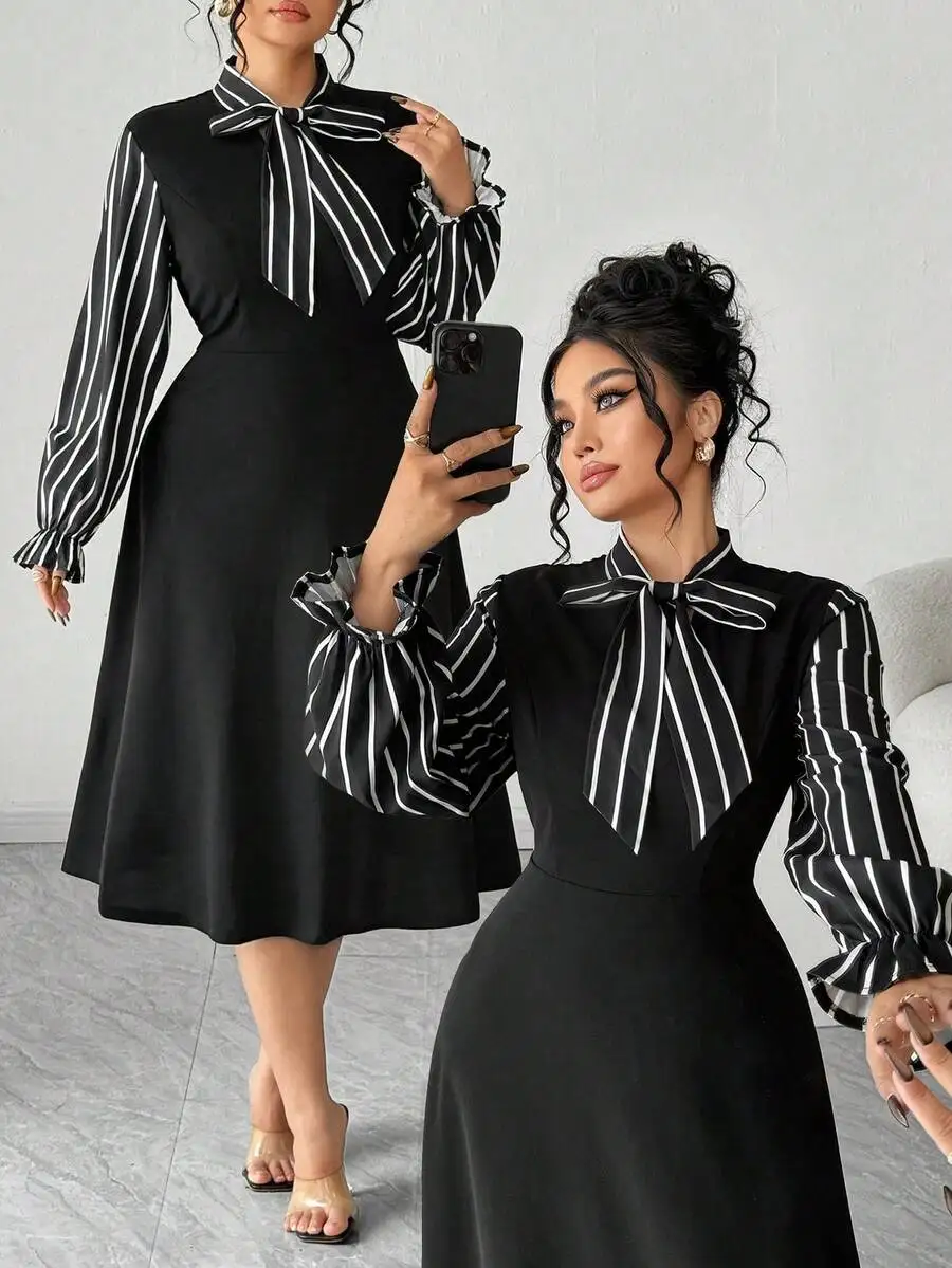 

Черное женское расклешенное платье с длинными рукавами, в полоску, с бантом на горловине