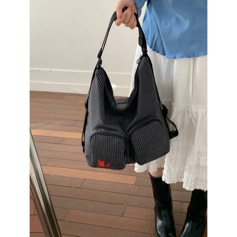 Trendy niche plaid multi-pocket backpack for women2026New large-capacity multifunctional casual commuter canvas bag