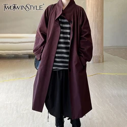 TWOTWINSTYLE Patchwork Pocket Loose Minimalist Coat For Women Stand Collar Long Sleeve Spliced Button Casual Trench Female New