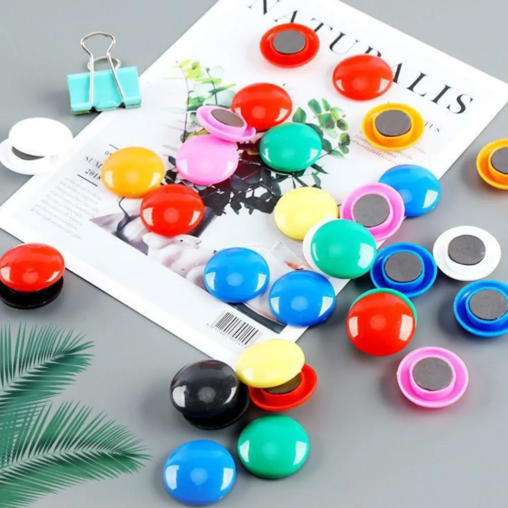 Bucket of colorful round magnets, fridge magnets, wall paper holders, black and white board magnets.