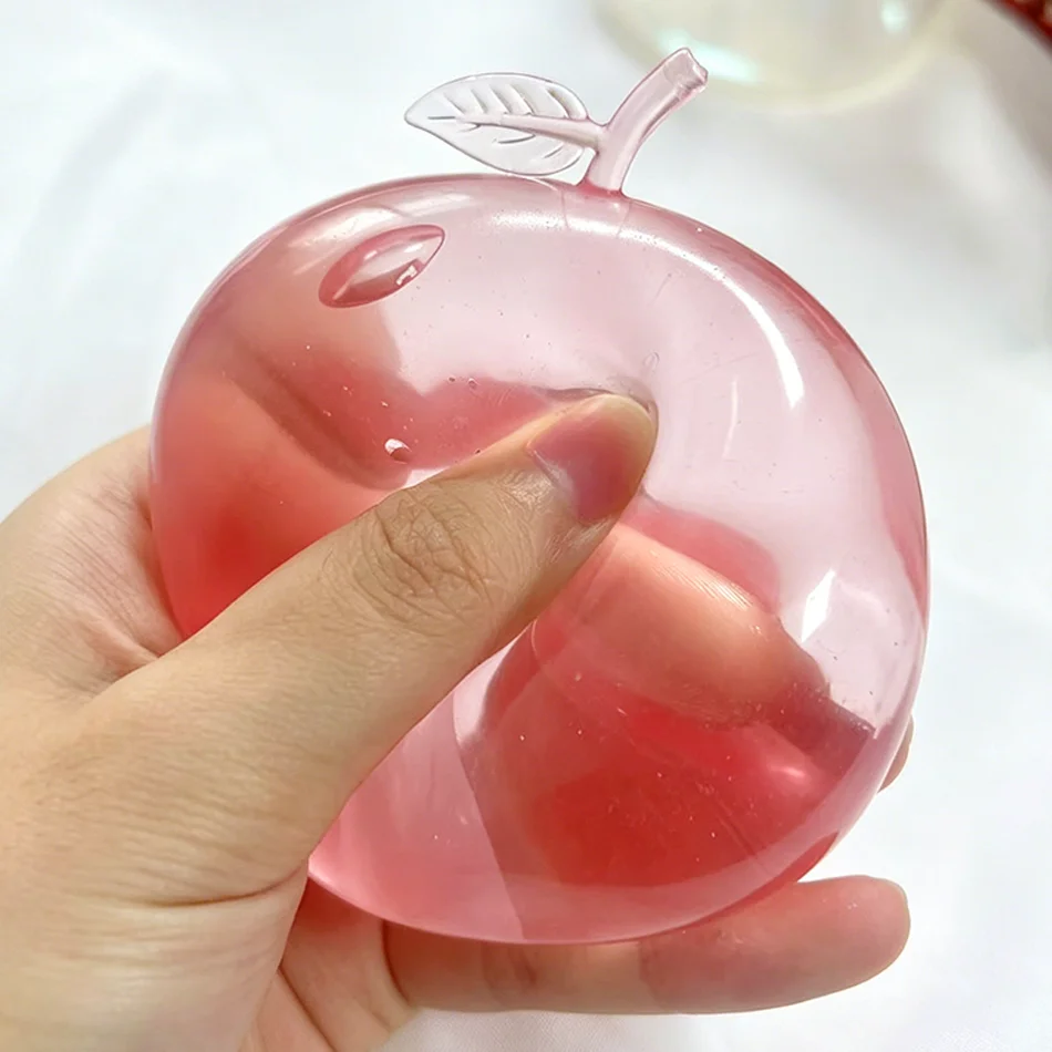 Heiß begehrte rosa Apfel-Quetschspielzeuge zur Stresslinderung und zum Ausdrücken von Wut, Fidget-Spielzeuge, plastische Quetschspielzeuge zur Stresslinderung für Freunde
