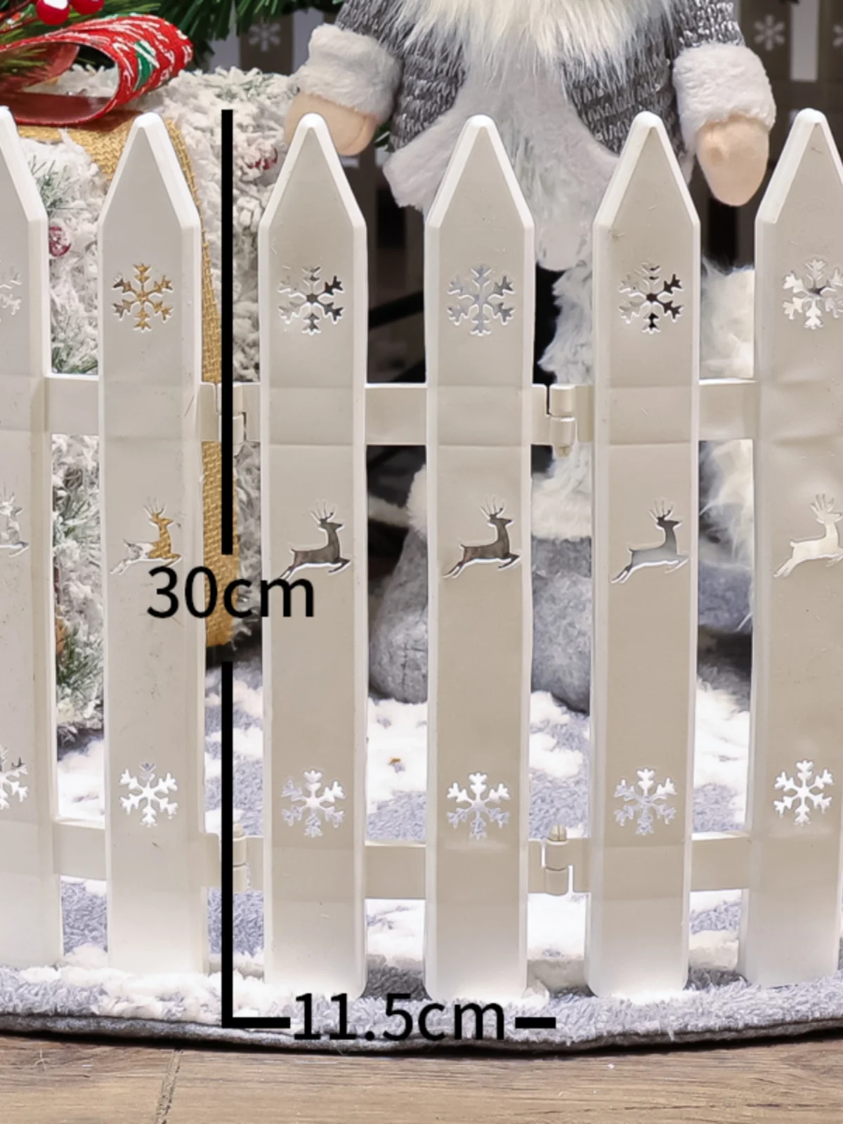 Christmas tree fence surrounded by white decorative items