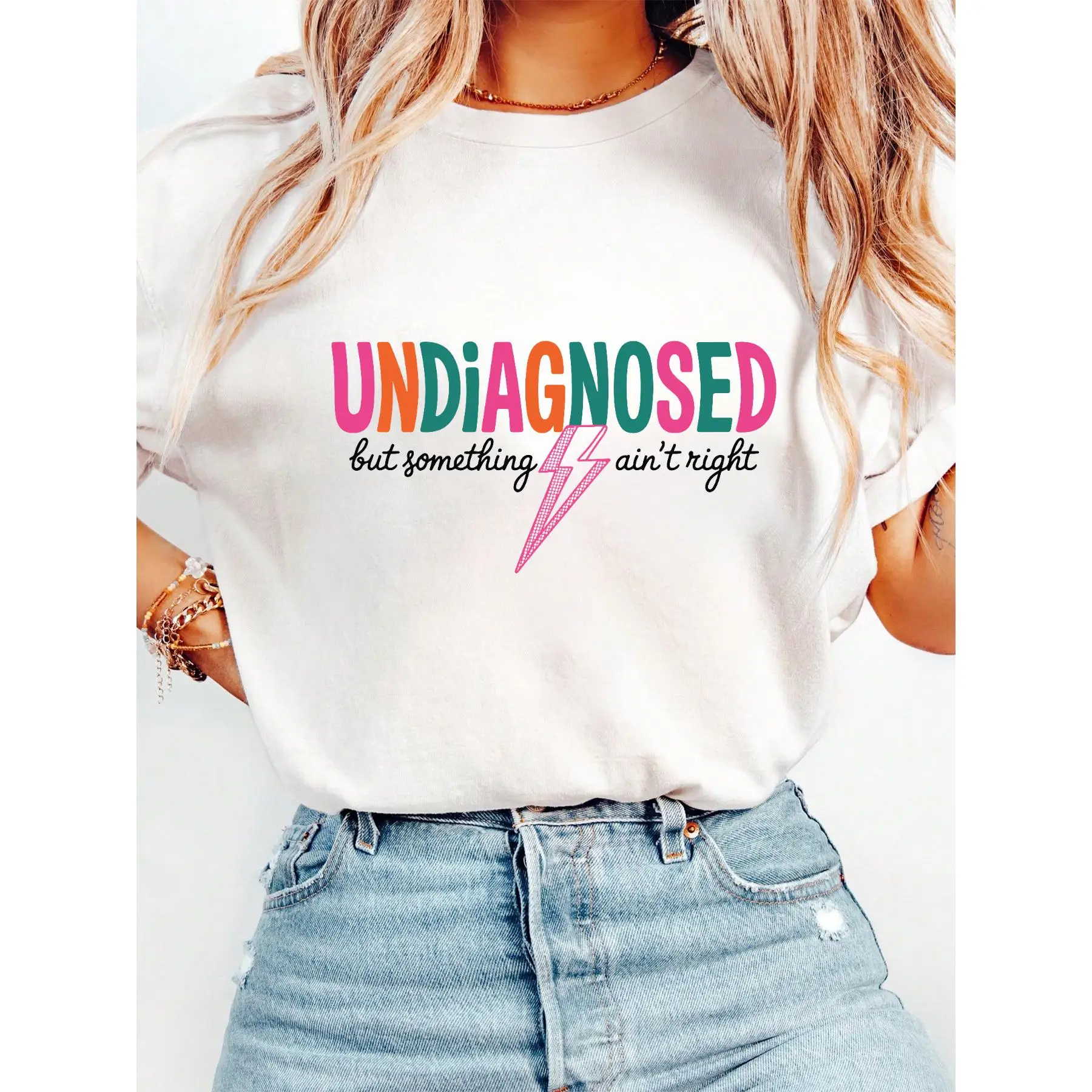 

T - Shirt With “UNDXAGNOSED But Something Ain't Right” Slogan And Pink Lightning, For Those With Relatable Humor.