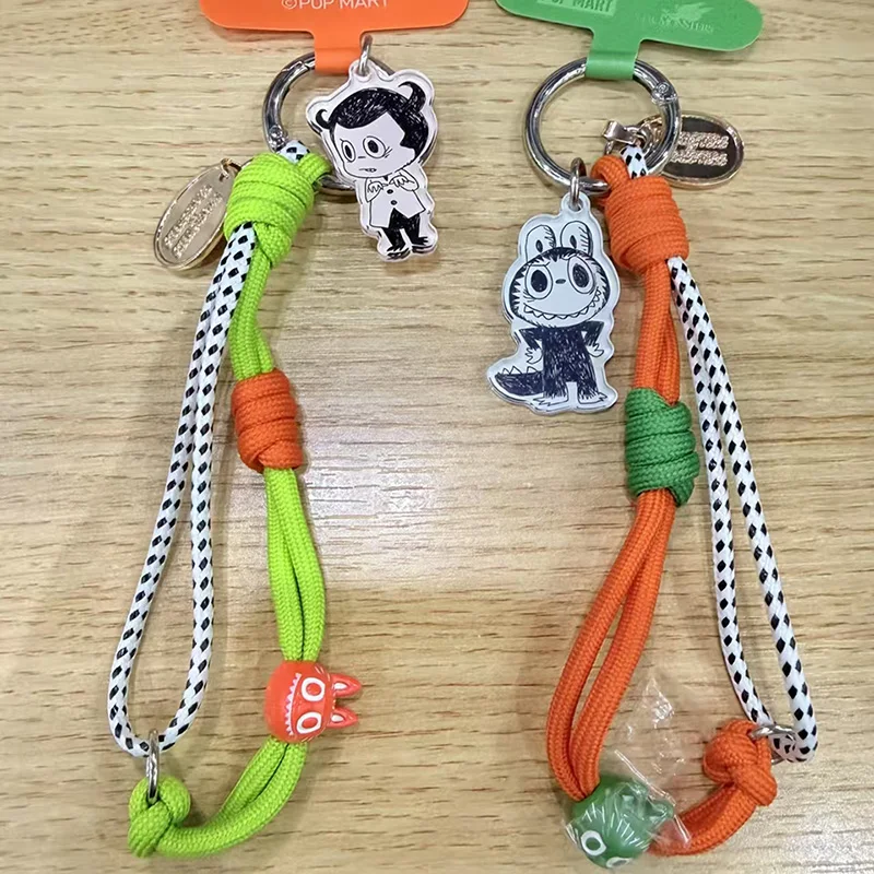 

POP MART LABUBU THE MONSTERS Серия к 10-летию: Секретный бокс с ремешком для телефона (оригинальный, случайный набор)