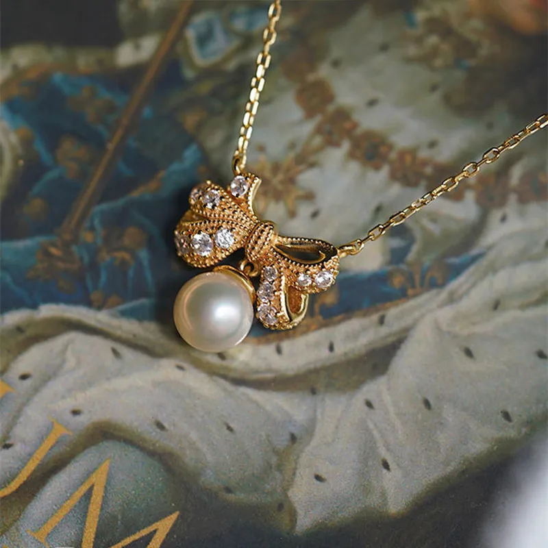 

French Luxury Style Gold Color Imitation Pearl Bow Inlaid Zircon Pendant Necklace Women's Afternoon Tea Party Jewelry Necklace