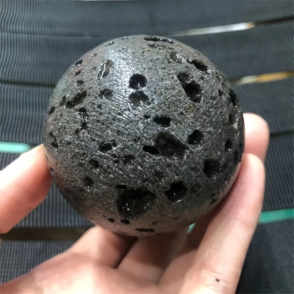 A volcanic rock crystal ball—a solid volcanic rock specimen with lava flow patterns, suitable for home decoration, collection