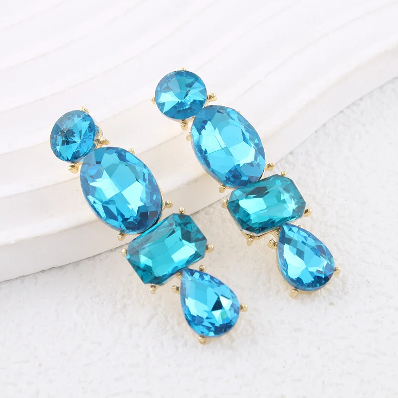 Luxurious and elegant long earrings with striking colored gemstones, perfect for travel, public relations, and social occasions