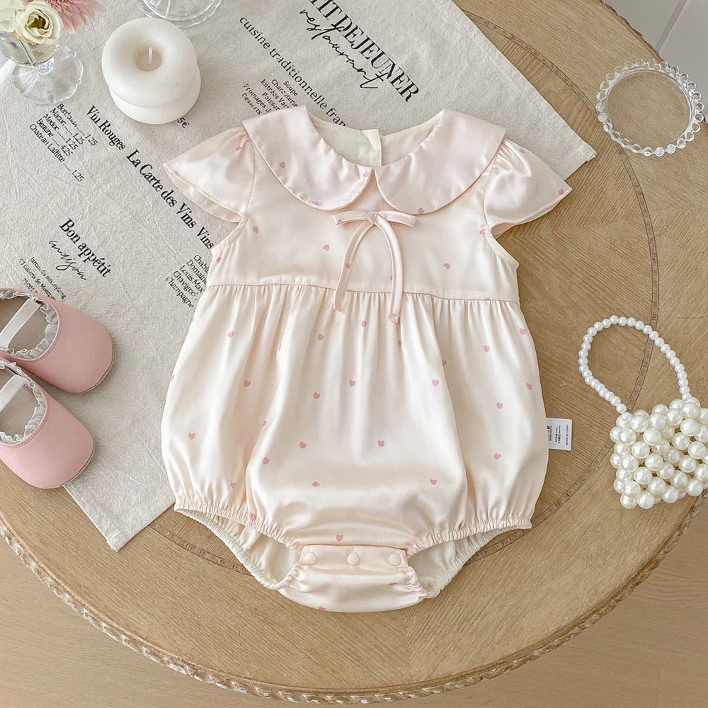 

2025 Korean Satin Baby Girl Romper Pink Heart Print Peter Pan Collar Bow Tie Bubble Onesie 0 - 24M Photoshoot Party Outfit