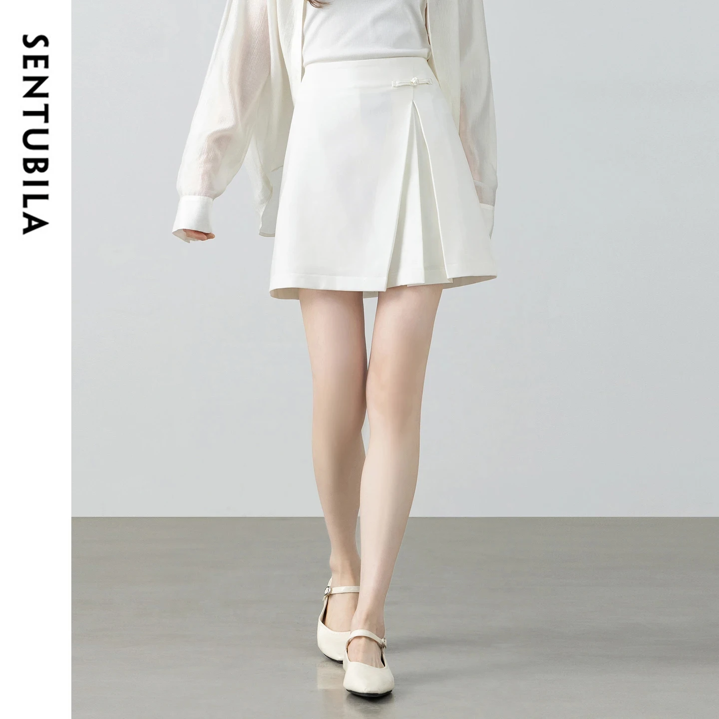SENTUBILA Women's White A-Line Skirt 2026 Summer New Fashion Frog Button Asymmetric Pleated Casual Office Mini Skirt 162QA6788