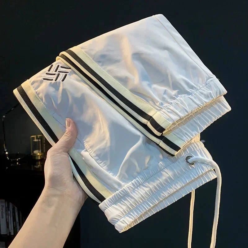 

Дышащие мужские повседневные брюки на лето, тонкий крой, свободный носок, элитная мода, спортивные спортивные штаны из ледяного шелка.