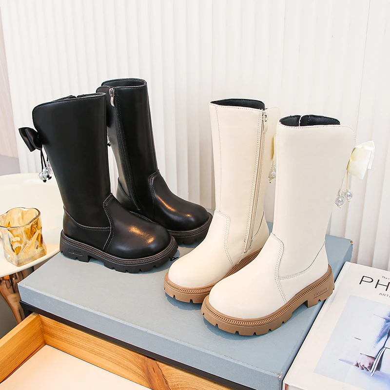 

2025 Новые детские модные ботинки с бантиками, модные детские высокие сапоги с боковой молнией, осенние новые сапоги принцессы для девочек с круглым носком, мягкая подошва