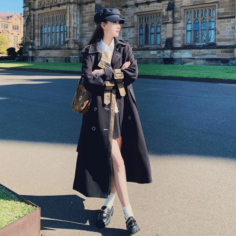 

A new mid-length women's coat designed with unique color contrast and patchwork black trench