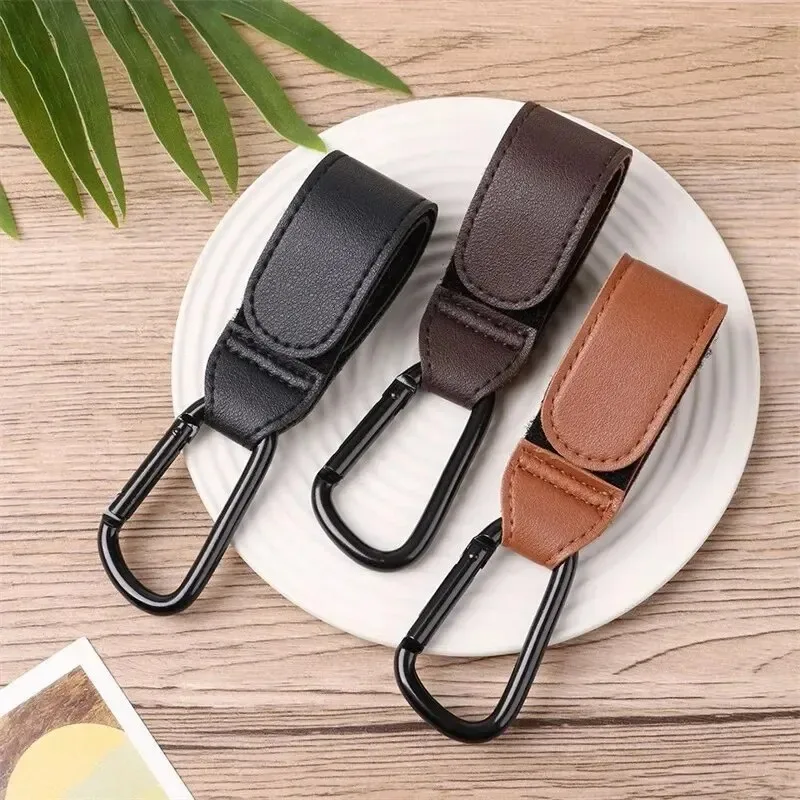 Gancho de cuero PU para cochecito, gancho ajustable versátil para organizar accesorios, soporte fuerte de alta calidad, 1/2/4 Uds.