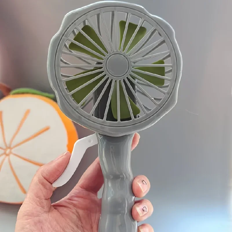 Hand-cranked fan, cartoon hand-cranked fan, manual airflow mini fan, handheld small portable fan.