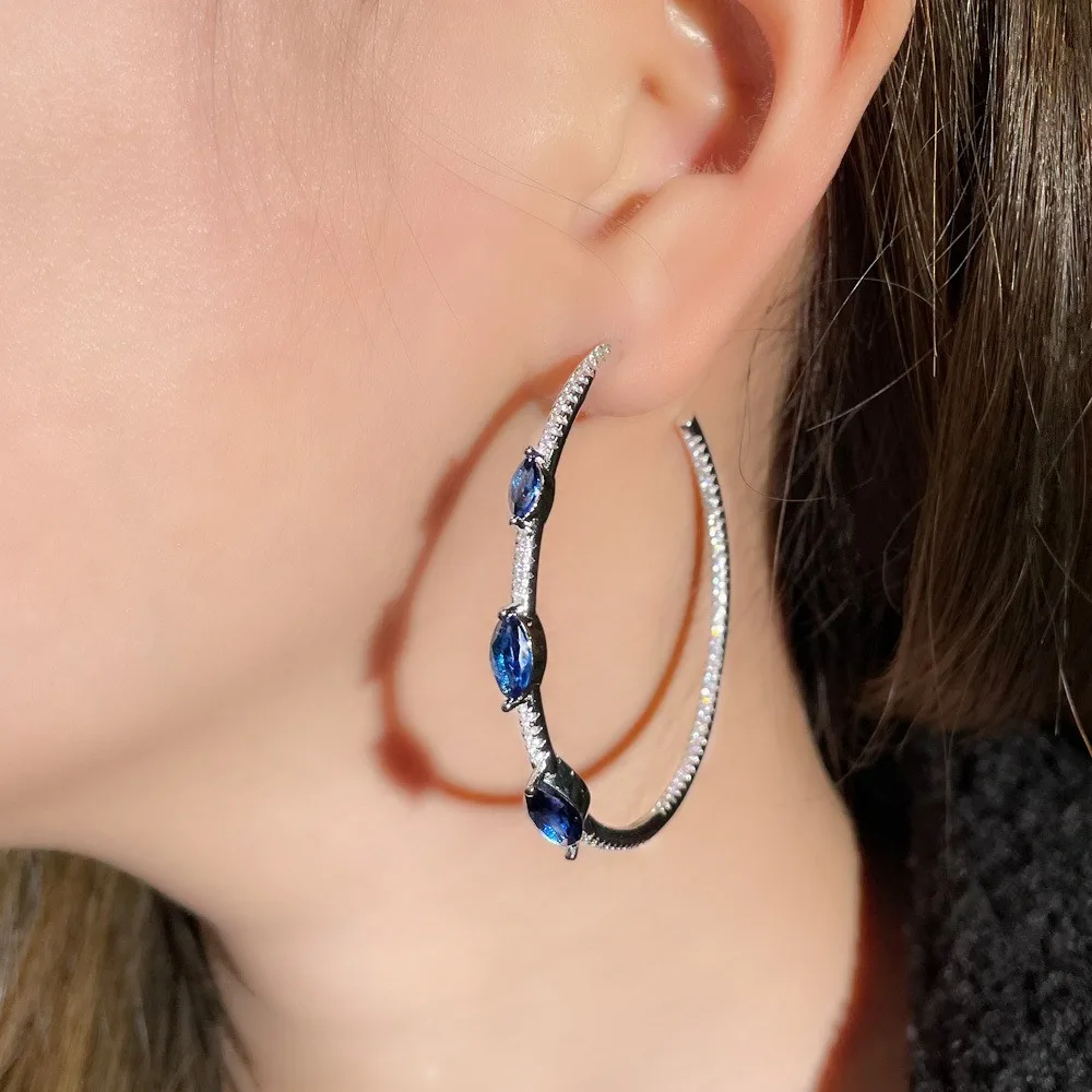 

Round Hoop Earrings with Inlaid Sapphire Blue Cubic Zirconia, Made of S925 Sterling Silver, Stylish and Simple Design for Women.
