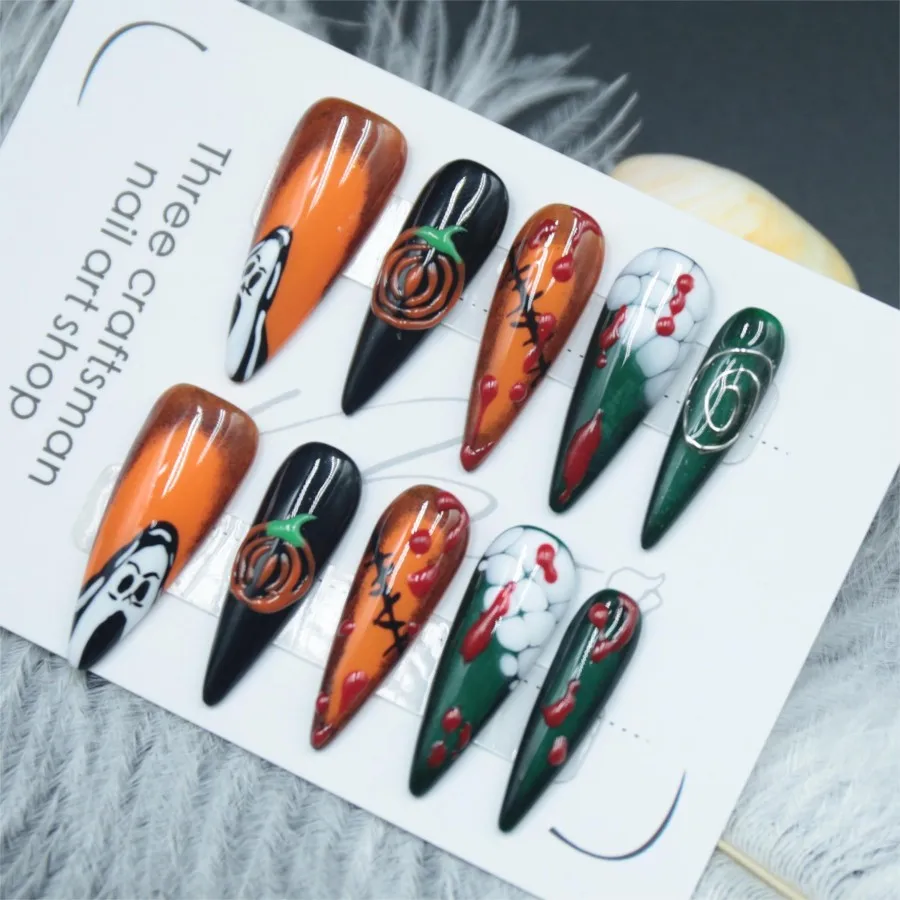 Handmade pressed fake nails, pumpkin Halloween elements, adhesive fake nails, long pointed styles, finished nail art,