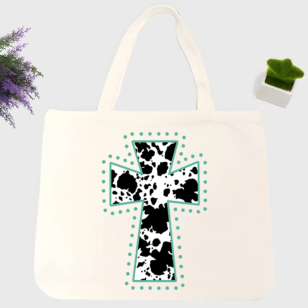 Women's cow print cross canvas tote bag with teal trim, perfect for casual daily use and shopping outings