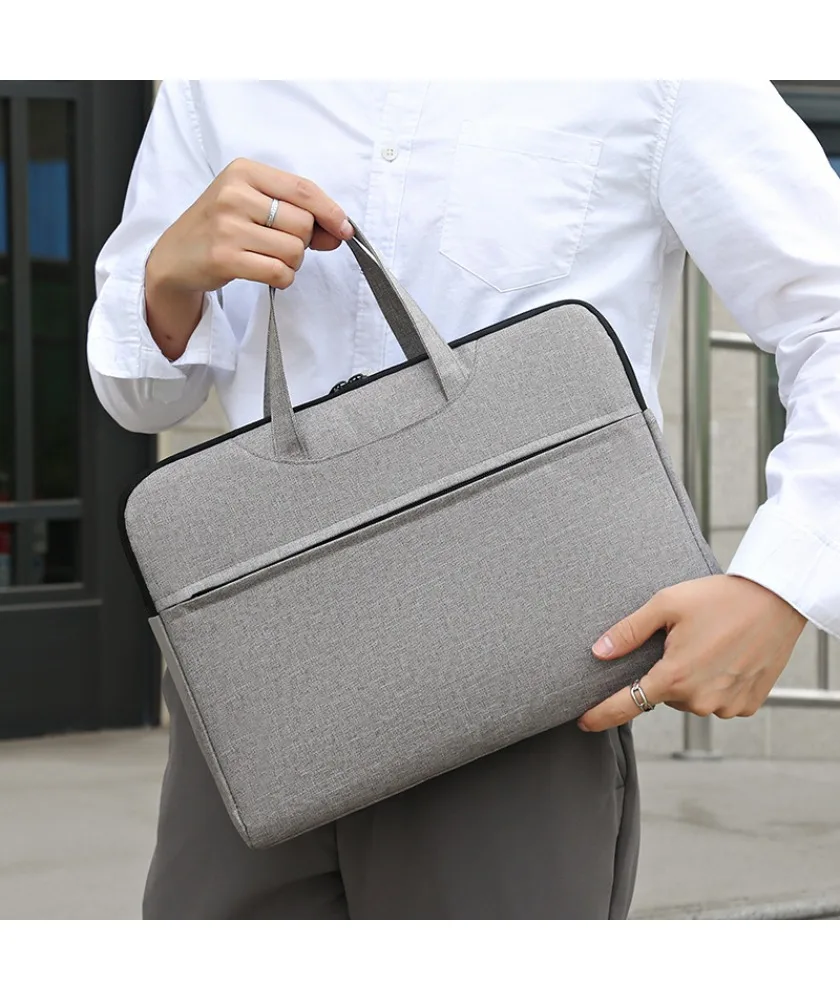

Gray canvas laptop bag with front slip pockets black trim lightweight fabric suitable for work school and casual use