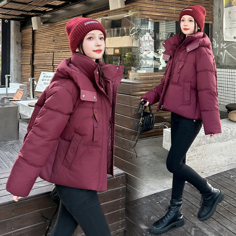 2025 Nuova giacca corta in cotone con design a nastro invernale da donna spessa Parka cappotti manica lunga tasche con cerniera con cappuccio abbigliamento casual tendenza