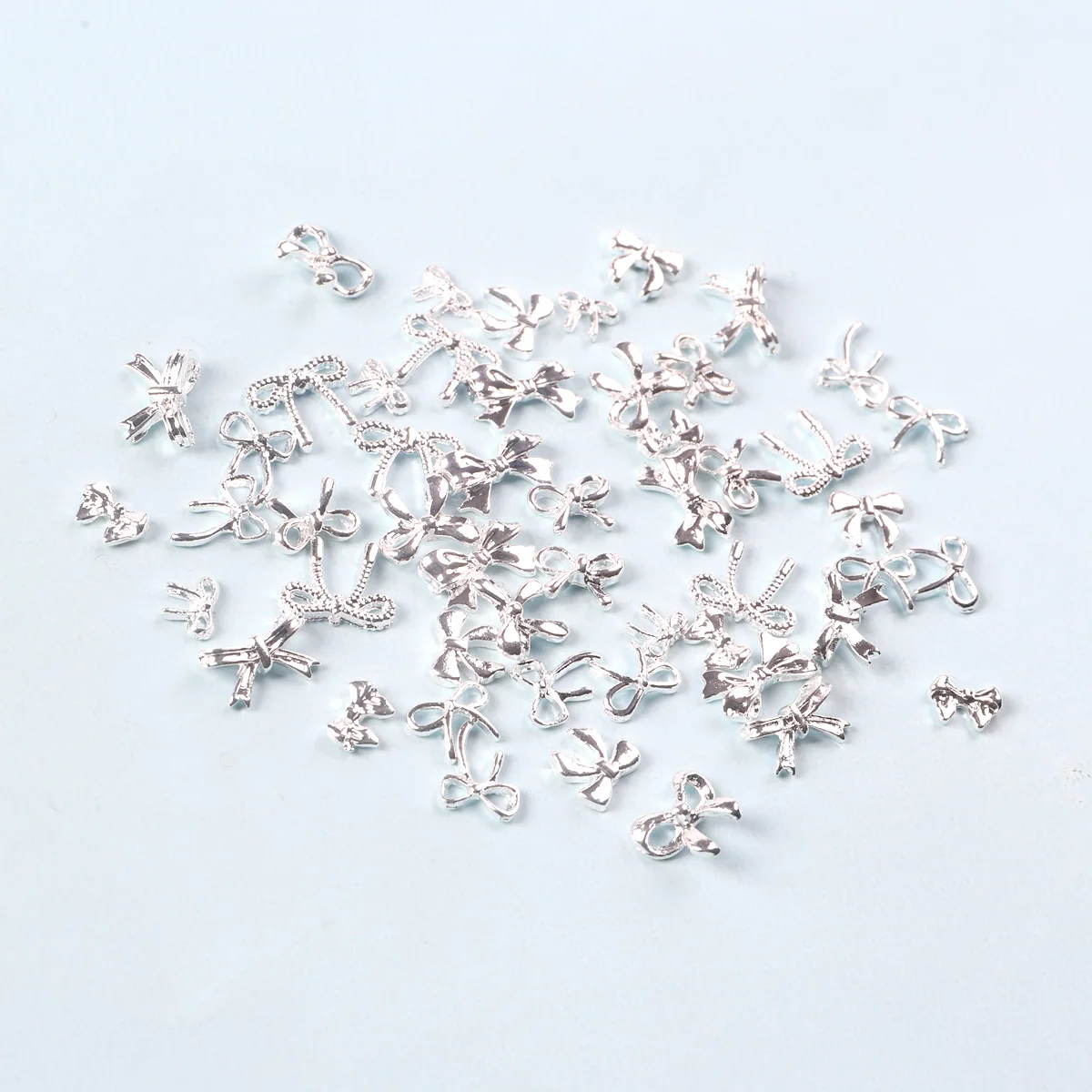 TSZS الفضة ثلاثية الأبعاد القوس مسمار الفن سحر سبيكة معدنية لطيف مزيج صغير شكل القوس الشريط الأظافر الديكور DIY بها بنفسك مسمار الملحقات