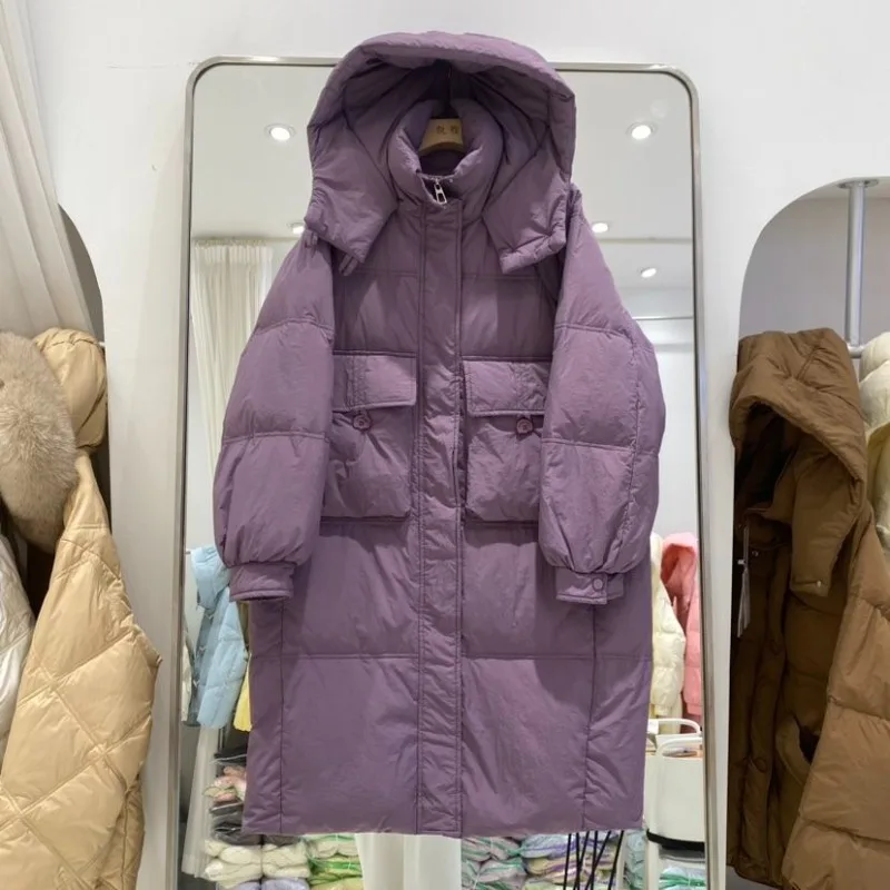 Giacca da donna media e lunga sopra il ginocchio 2025 Nuova versione coreana Moda allentata ispessita con cappuccio Piumino d'anatra bianco Marea