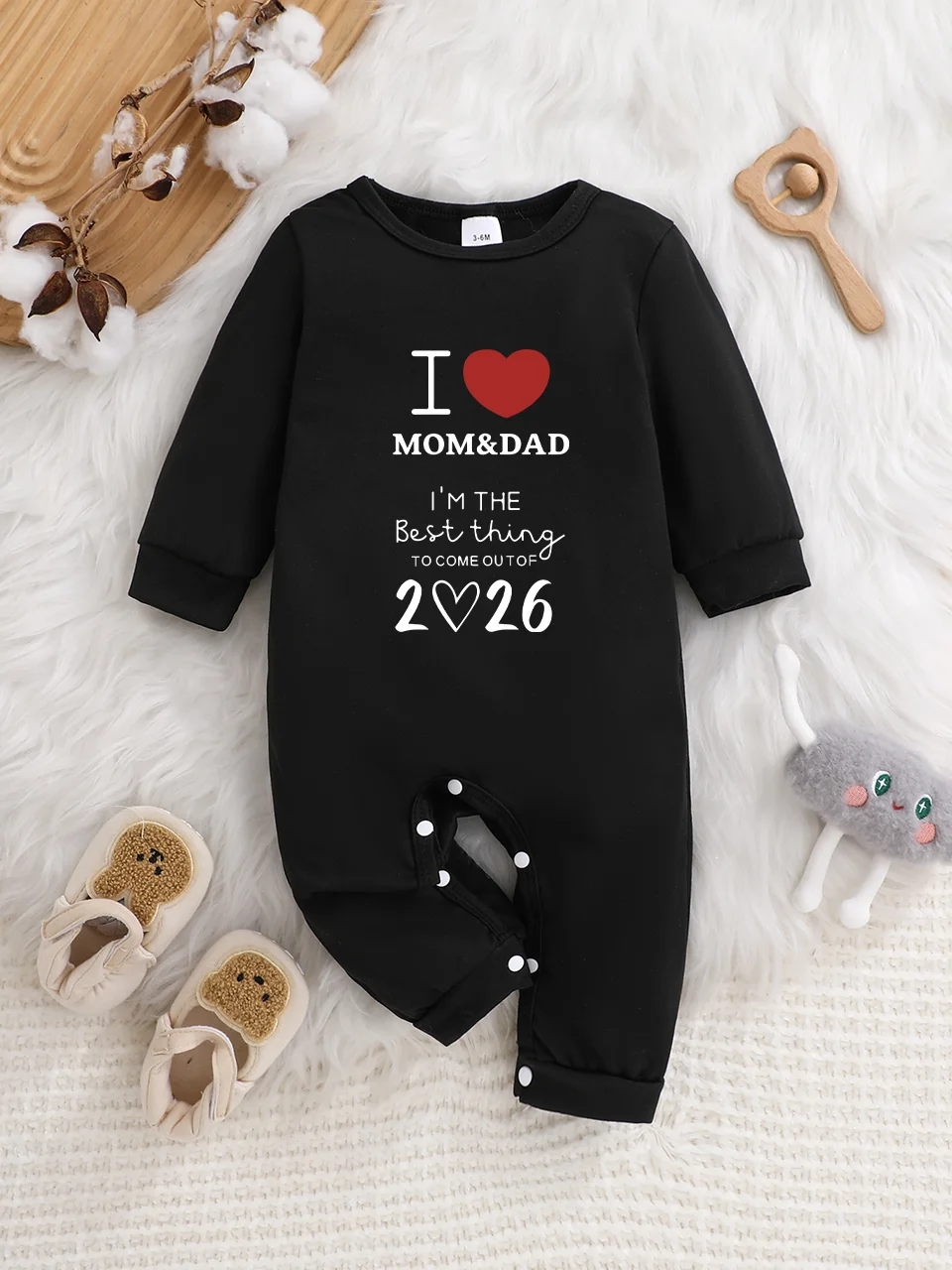 Baby long-sleeved bodysuit with fun letter prints, button design, easy care, suitable for new parents.