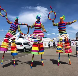 Amusement park tour interactive stilts colorful clown party atmosphere bar costume