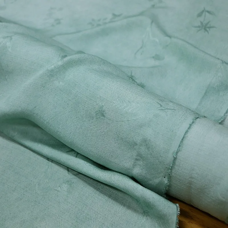 

A new jacquard dirt-dyed fabric made of tussah silk with clear blue and green color from