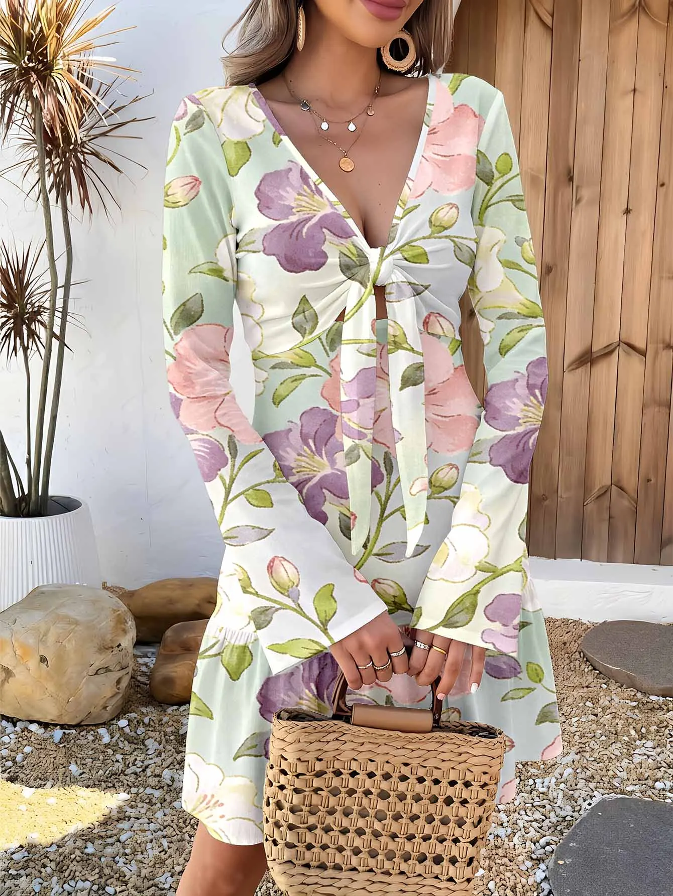 Deep V-neck long-sleeved waist-cinched short skirt, with intricate cut-out detailing to create a romantic vibe