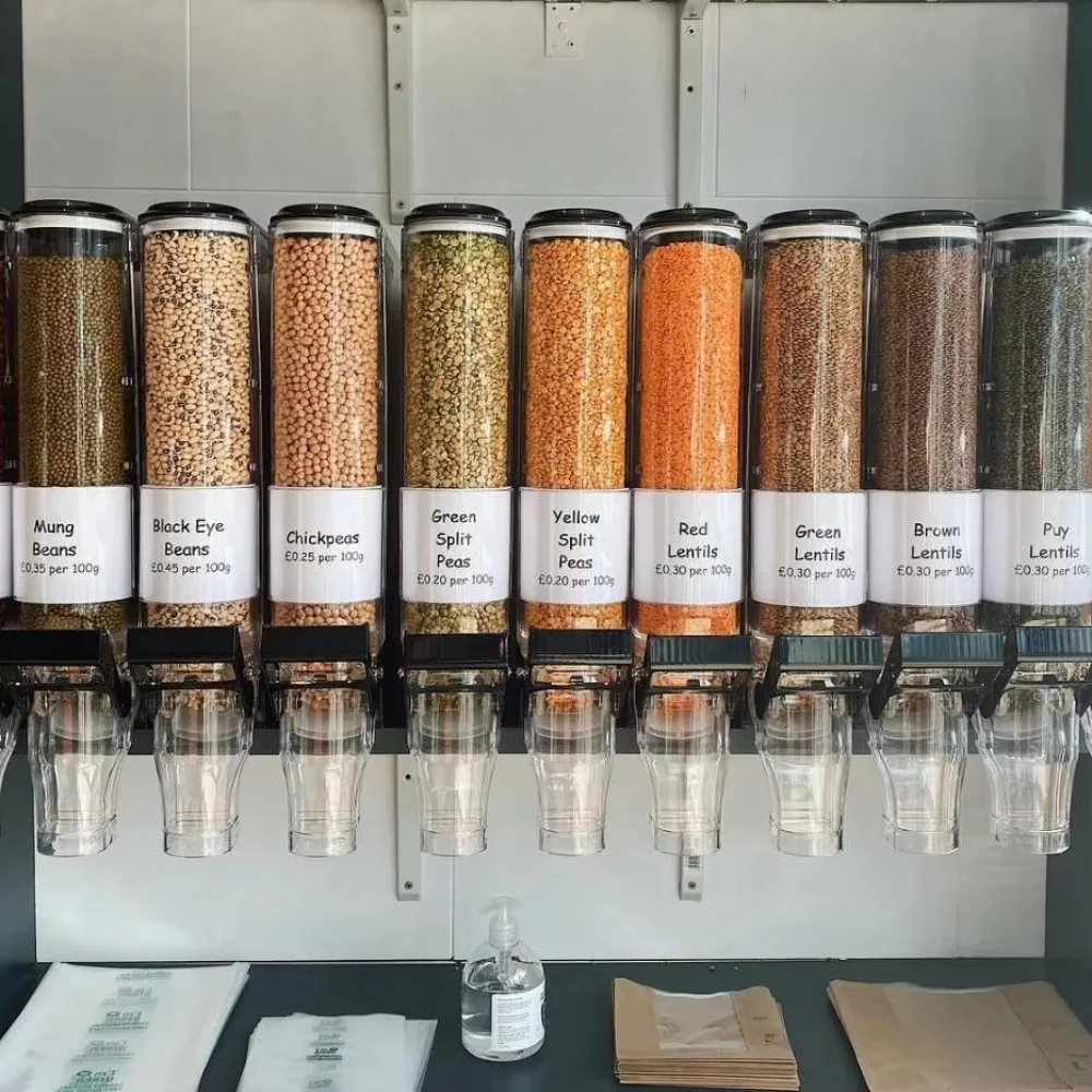 Food-grade plastic gravity-fed narrow bulk wall-mounted snack dispenser, suitable for retail display of dry foods such as nuts (