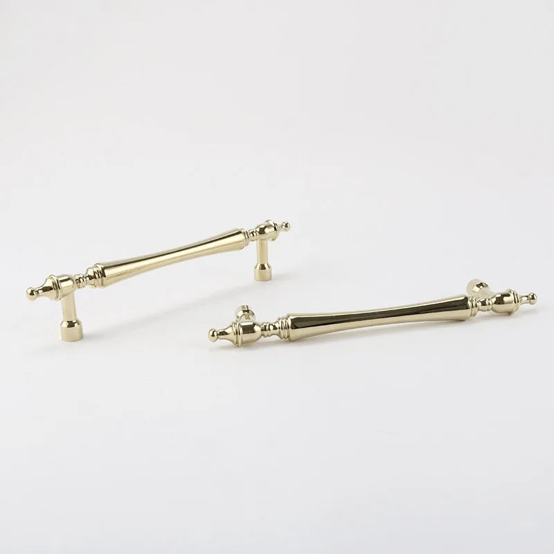 Gold brass pulls positioned to show their side profile